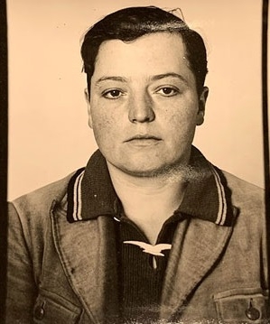 Mugshot of _Spindler. He wears a collared shirt and a leather jacket, his hair combed back.