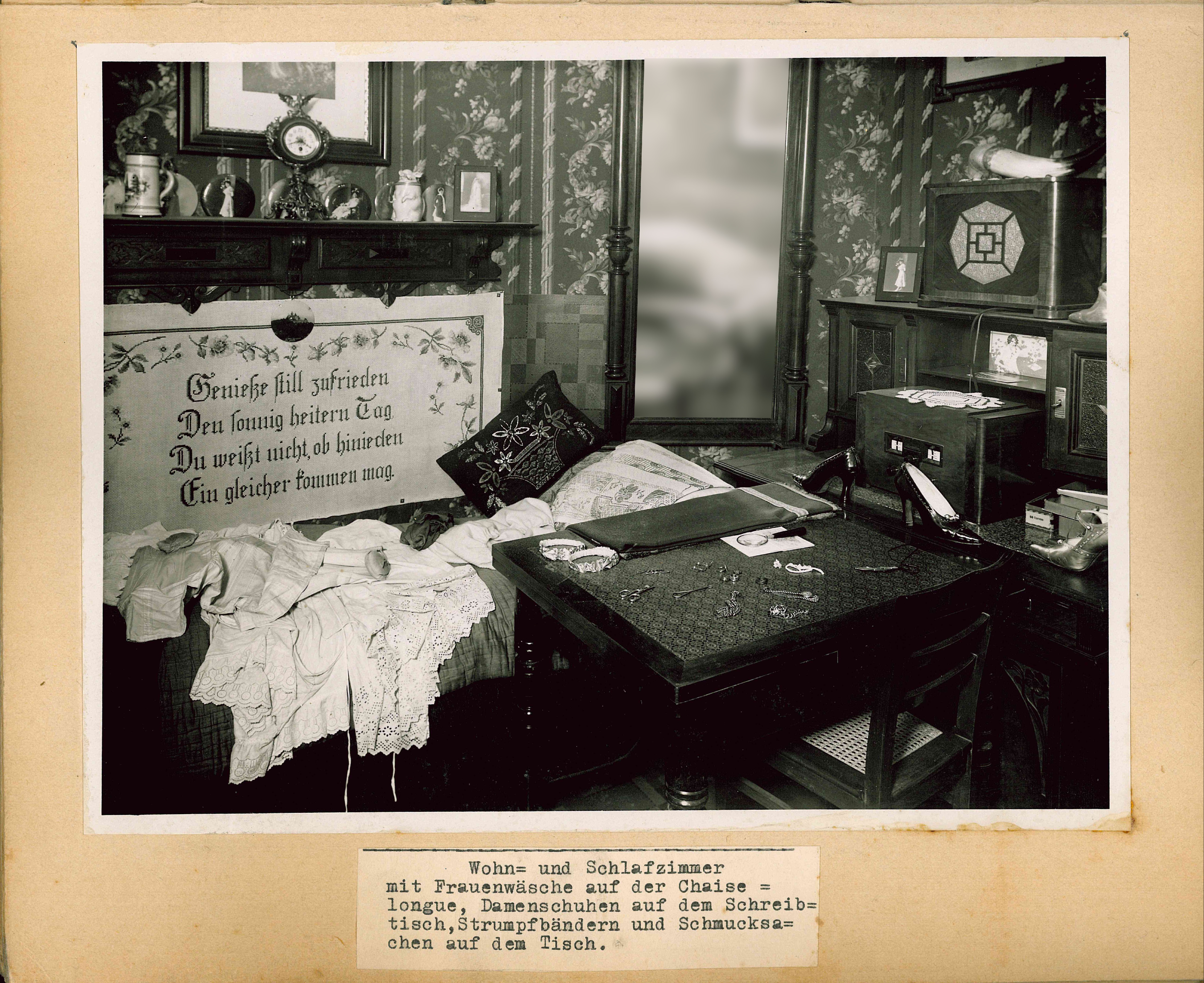 Table with jewelry and heels lying on it, vanity with make-up, nightgown hanging on the wardrobe.