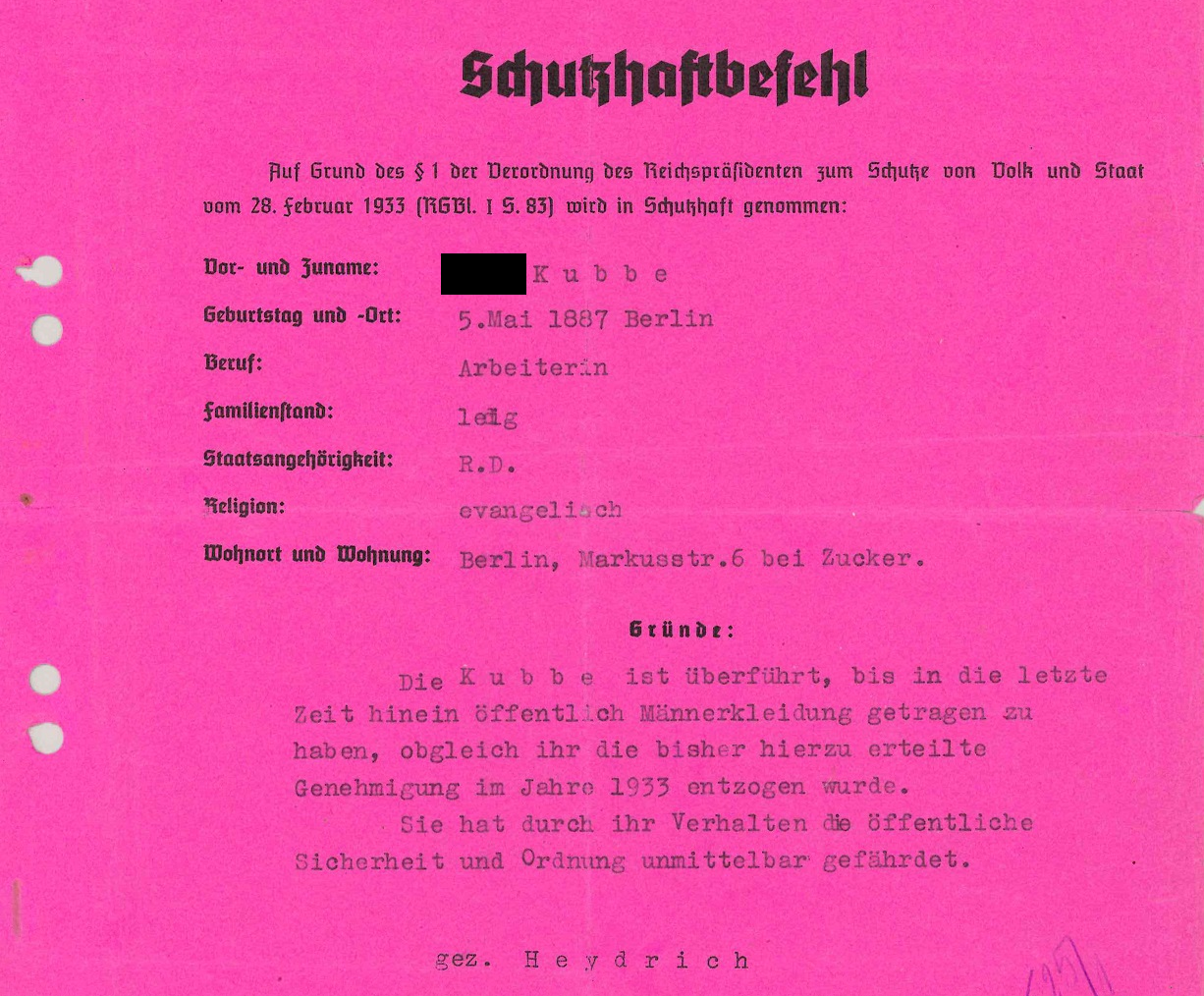 Excerpt of pre-printed form with personal data in typewriter font: Schutzhaftbefehl [Protective Arrest Order], On the basis of § 1 of the Decree of the Reich President for the Protection of the People and the State of February 28, 1933 (RGBl. 1 p. 83) is taken into protective custody. First and last name: (deadname blackened) Kubbe, date and place of birth: May 5, 1887 Berlin, occupation: worker, marital status: single, nationality: R.D., religion: Protestant, place of residence and apartment: Berlin, Markusstr. 6 at Zucker, reasons: Kubbe is convicted of having worn men's clothing in public until recently, although the permission she had previously been granted to do so was withdrawn in 1933. She directly endangered public safety and order through her behaviour. sig. Heydrich.